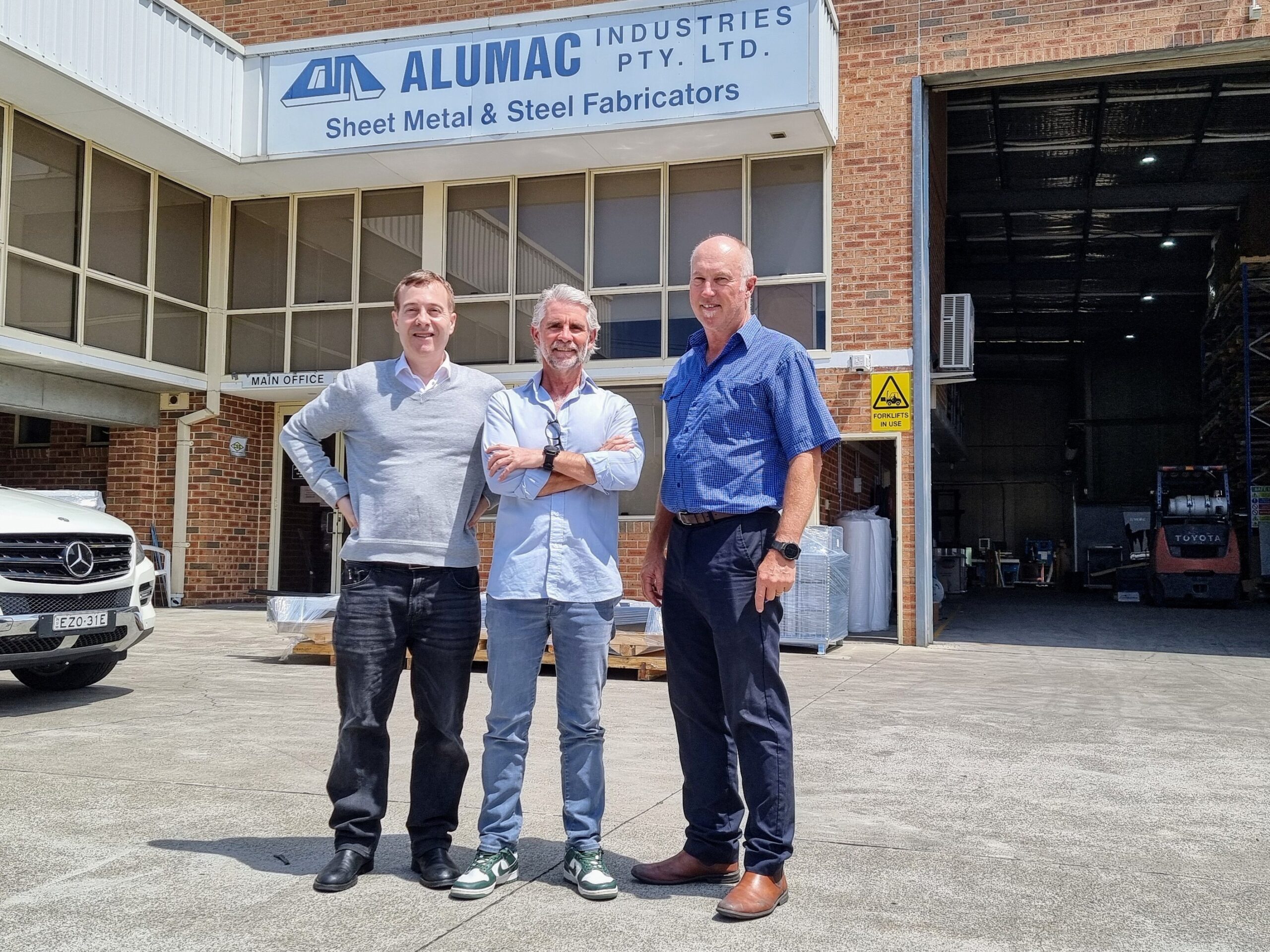 AI Innovators at Work: Alumac Manufacturing Facility, Sydney, Australia. (L-R) Peter Carr (Omnisenti), Dave Gair (Cloud Kitchen), and Greg Wallis collaborate on transformative AI solutions.